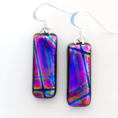 Purple and pink dichroic glass earrings with a shiny metallic finish.
