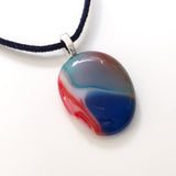 Light blue and red pebble style fused glass pendant